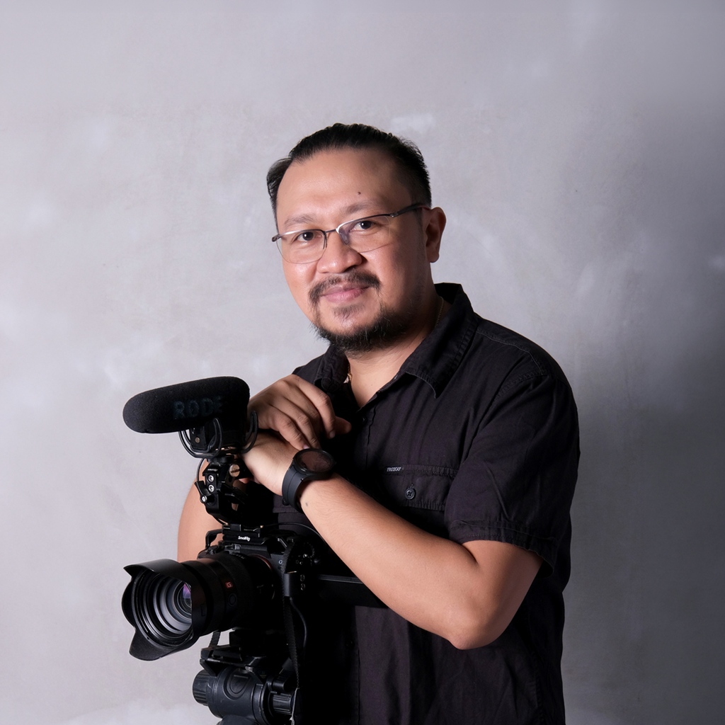 Professional photographer at golden hour on a tropical beach
